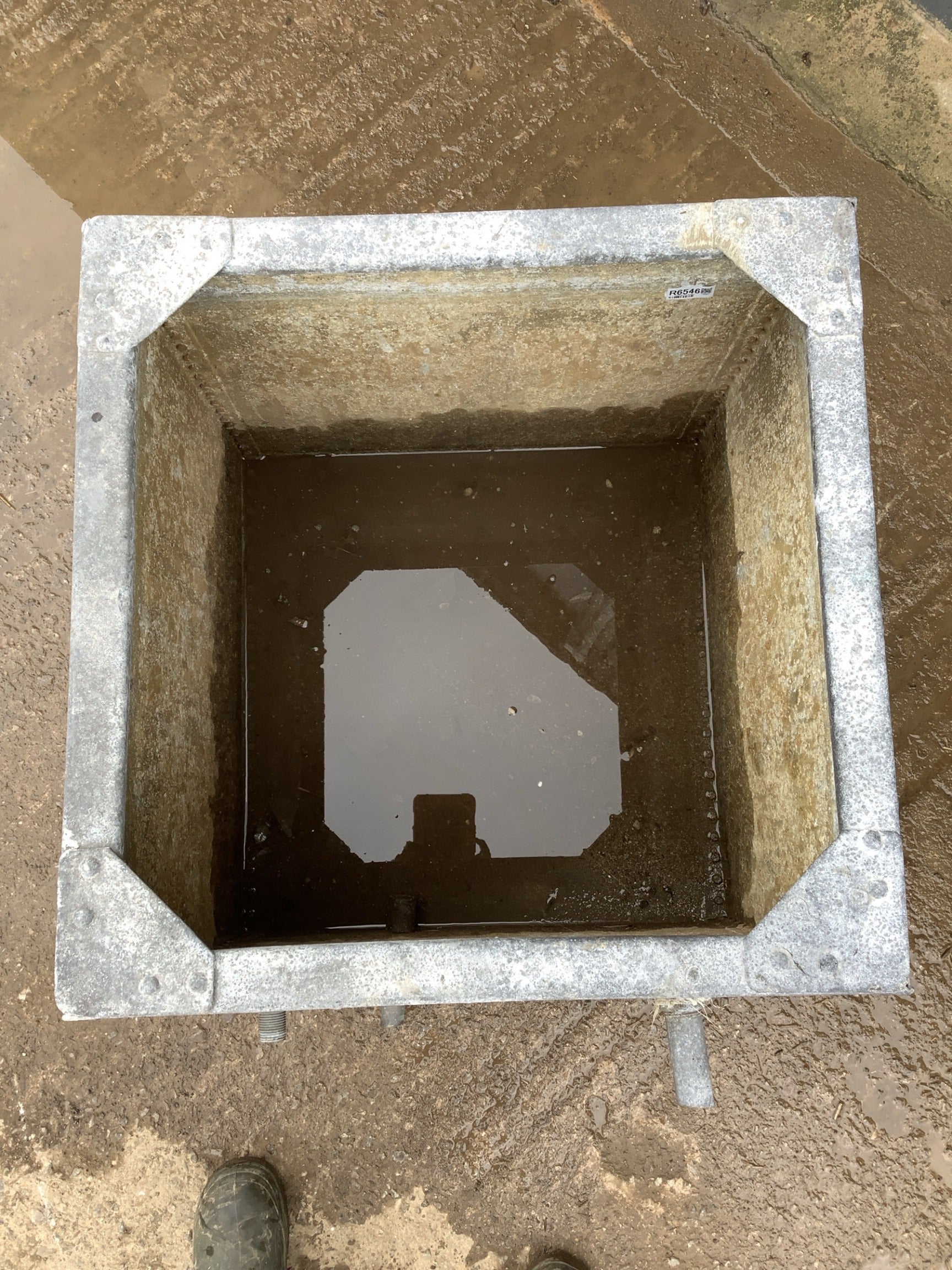Currently holding a bit of water in the bottom but only up to out let pipe